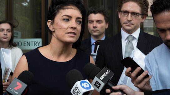 Emma Husar talks to the media outside court after her defamation case against Buzzfeed in Sydney in December.