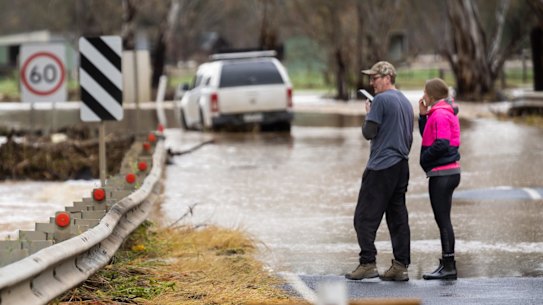Locals survey the damage in Seymour after flooding. A car caught in the floodwaters on the Goulburn Valley Highway. 