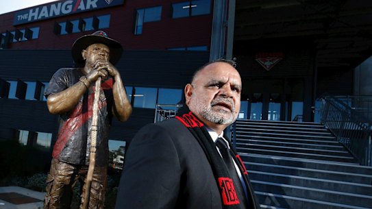 Essendon great, Michael Long poses for a photo in front of a new statue of him unveiled at the Essendon Football Club on July 17, 2018 in Melbourne, Australia. 