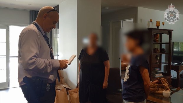 Detectives searched a Highgate Hill home and charged a 74-year-old woman in Queensland with nine counts of fraud regarding a multimillion-dollar global investment scheme.