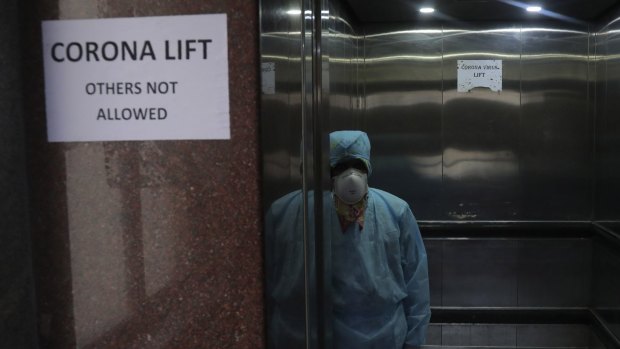 An Indian lift operator stands inside a dedicated lift for people suspected to be infected with the new coronavirus at the Government Gandhi Hospital in Hyderabad on Monday, March 2.
