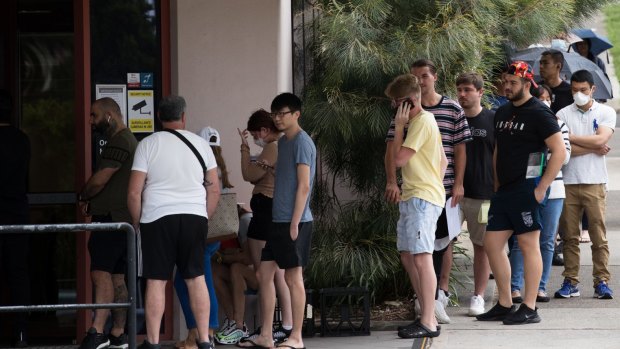 People queue outside a Centrelink office in Sydney. In April alone, more than 221,000 people lost their jobs in NSW.