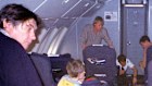 Singer Bryan Ferry (left) watches as British Airways flight crew prepare to carry a suspected hijacker off their Kenya-bound flight on December 29, 2000, after overpowering him.
