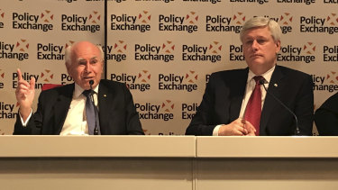 Former PM John Howard and former Canadian PM Stephen Harper speak at a Policy Exchange seminar in London.
