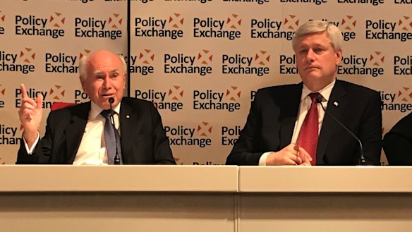 Former PM John Howard and former Canadian PM Stephen Harper speak at a Policy Exchange seminar in London.