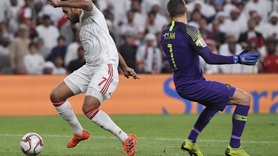 United Arab Emirates' forward Ali Mabkhout dribbles past Australian goalkeeper Mat Ryan to score an easy goal. 