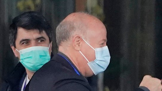 WHO investigator Peter Daszak, left, bumps fists with Peter Ben Embarek during their field visit in Wuhan.