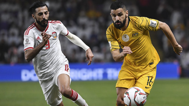 Australian defender Aziz Behich vies for the ball with United Arab Emirates' midfielder Bandar al-Ahbabi.