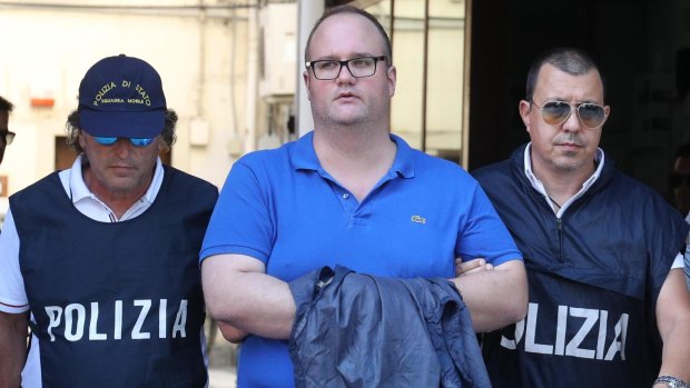 Torretta Mayor and Mafia suspect Salvatore Gambino, centre, is taken into custody in Palermo.