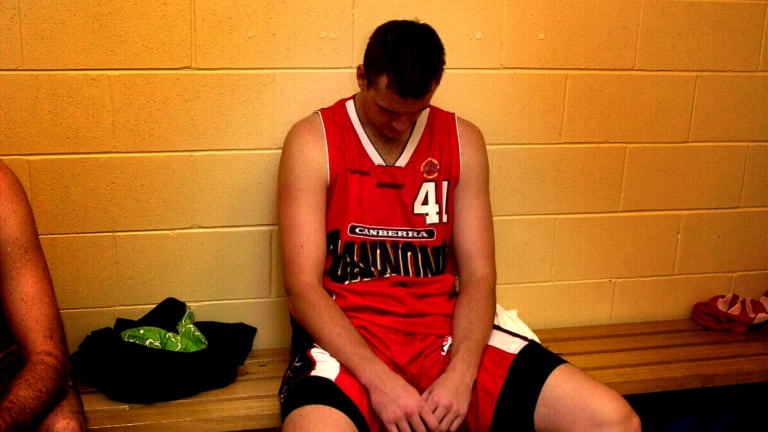 Blake Truslove slumped on a bench in the Cannons' change rooms after their final game in Canberra in 2003.