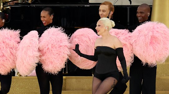 Lady Gaga perform amid a cloud of pom poms.