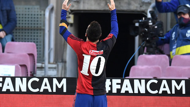 Lionel Messi of Barcelona celebrates after scoring their sides fourth goal while wearing a Newell's Old Boys shirt with the number 10 on the back in memory of former footballer, Diego Maradona.