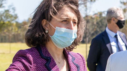 NSW Premier Gladys Berejiklian, left, and Treasurer Dominic Perrottet, far right, on Monday.