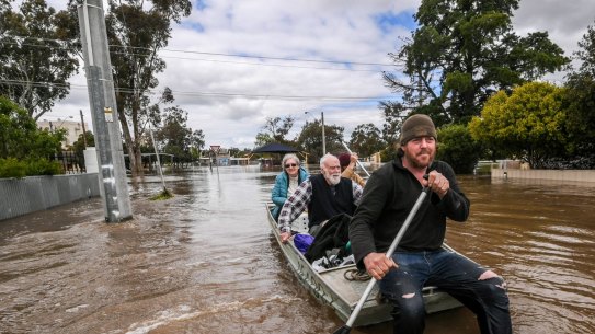 Tom Collins and mate Tim Tyler rescue Max and Julia Hastilow in Rochester in October.