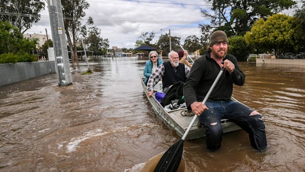 Tom Collins and mate Tim Tyler rescue Max and Julia Hastilow in Rochester in October.