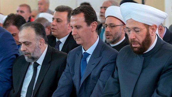 Syrian President Bashar Assad, second from left, prays on the first day of Eid al-Adha at al-Rawda mosque, in Damascus, Syria, last week.