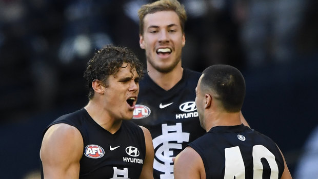 Charlie Curnow of the Blues (left) reacts after kicking a goal.