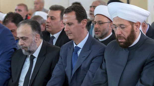 Syrian President Bashar Assad, second from left, prays on the first day of Eid al-Adha at al-Rawda mosque, in Damascus, Syria, last week.