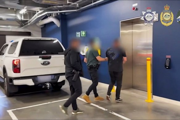 Police with one of the arrested men.