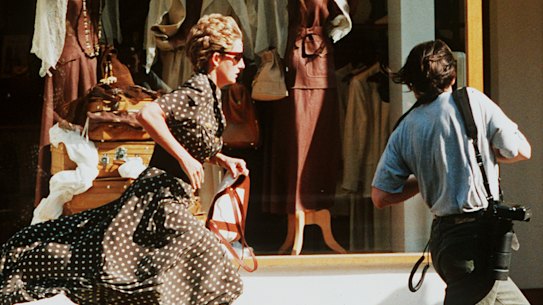 Diana runs from a pursuing photographer in 1997.