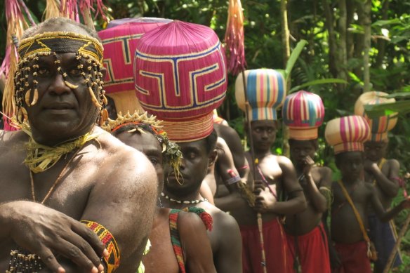 Young men in their Upe initiation hats, the symbol of Bougainville, line up to vote in the independence referendum in Teuapaii village.