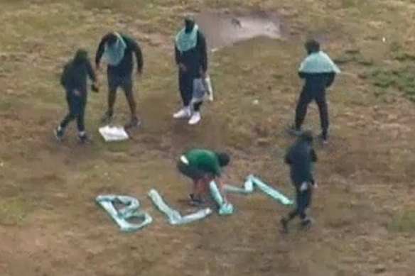 Inmates at Long Bay spell out BLM as tear-gas is deployed.