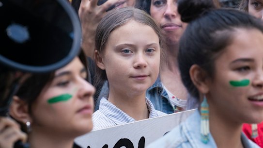 Swedish activist and student Greta Thunberg, centre, takes part in the Climate Strike, in Montreal on Friday.