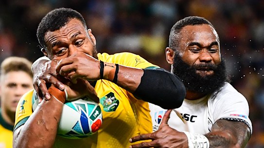 Fiji's Semi Radradra wraps up the Wallabies' Fijian-born centre Samu Kerevi on Saturday.