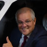 Prime Minister Scott Morrison leaning out of a Qantas plane on Thursday ahead of announcing the $1.2 billion industry package. 