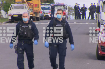 NSW Police gather at the scene of the Guildford shooting. 