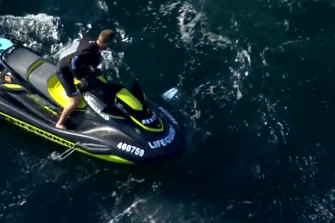A jet-skier searches for the shark after it attacked the swimmer.