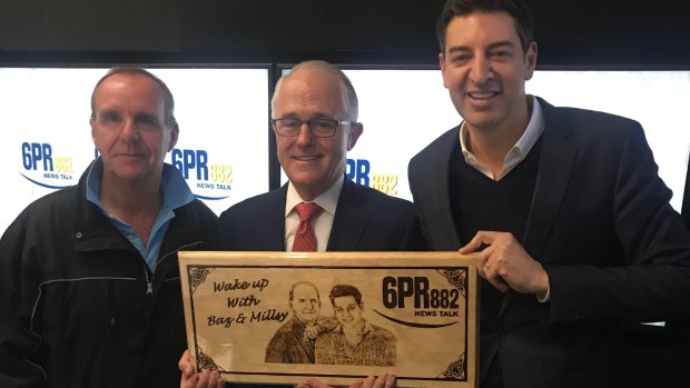 Prime Minister Malcolm Turnbull receives an honorary plaque from the 6PR Breakfast team.