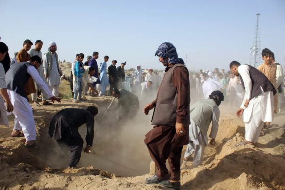 The bodies of security forces members killed in a suicide attack in Kunduz province, north of Kabul, are buried on Sunday.