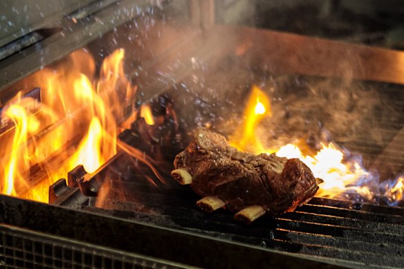 After being slowly braised in the oven, beef ribs are finished on a gas chargrill.