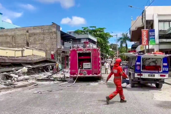 Rescue personnel survey the damage to a building in Port Vila on Tuesday.