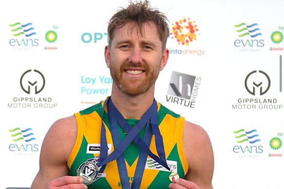 Former Essendon player Dyson Heppell displays his Stan Aitken Medal and best-on-ground medal after winning the Gippsland League grand final with his hometown club, the Leongatha Parrots.