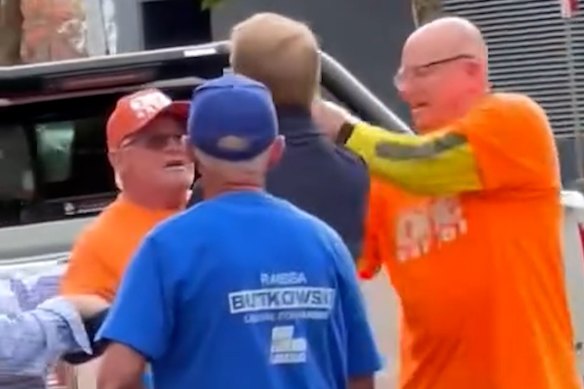 Screengrabs from footage showing a One Nation volunteer grabbing Liberal Senator James Paterson’s phone following a confrontation outside a polling booth in Albury.