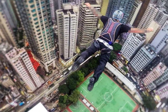 The man BASE jumping from a building in Hong Kong.