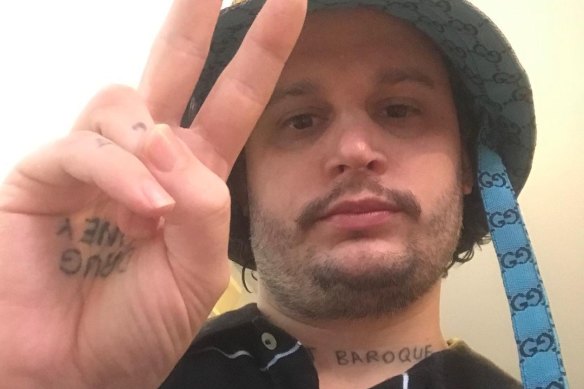 Benjamin Aitken has the words “drug money” tattooed on his palm and “flat baroque” on his neck.