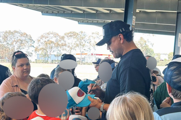 Latrell Mitchell signs hats for fans at Apex Oval in Dubbo. 