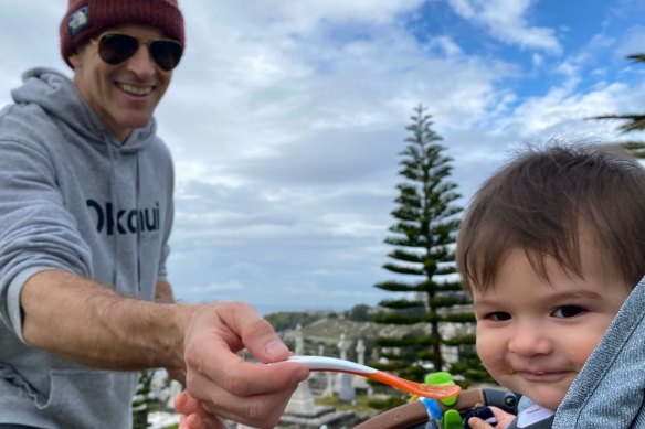 Osher feeding son Wolfgang – the reason trackies are the go.