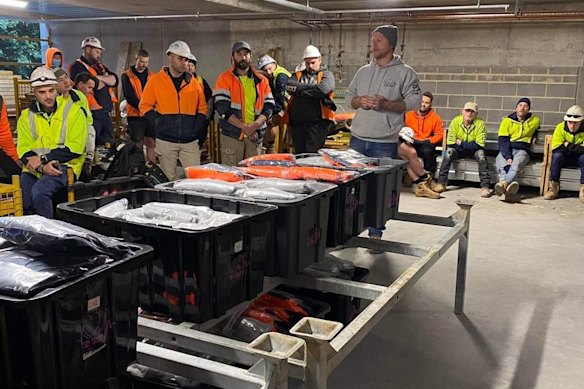 Mark Henry addresses a site meeting for the Team Taylor charity with some of the charity’s merchandise.