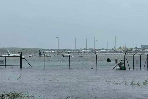 Planes partially submerged on the Cairns Airport tarmac in flooding caused by Cyclone Jasper.