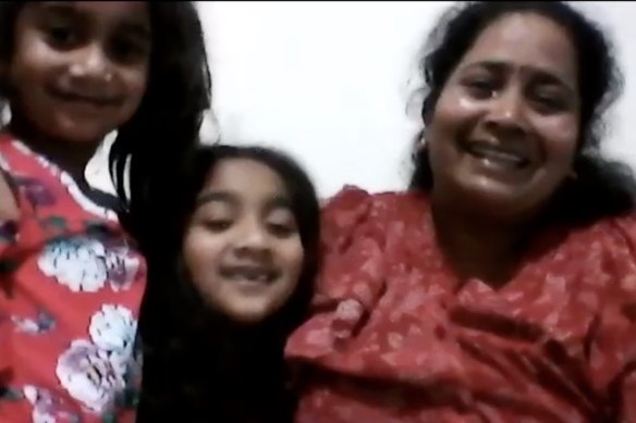 A tearful Priya Murugappan celebrates with daughters Kopi and Tharni on hearing the news that they can return to Biloela after Labor won the election.