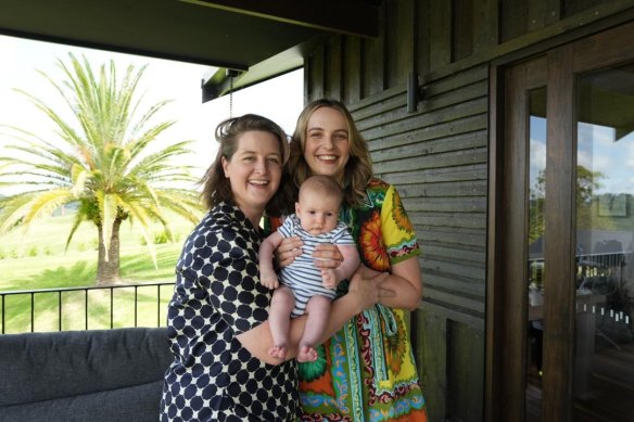 Flora Grant (right) with wife Liz Astey and baby Franklin welcome the news of a rate cut as they transition to a larger family home. 