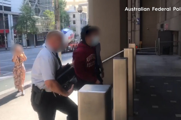 Aran Sherani (right) is escorted into the Australian Federal Police headquarters in Melbourne after his arrest in 2021.