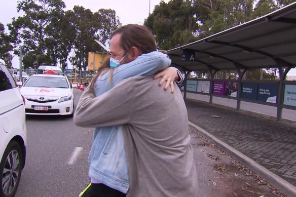 Tobias Moran is greeted by his wife at Perth Airport after flying back to WA.