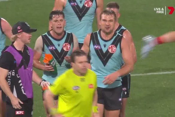 Zak Butters and other Port Adelaide players clash with the umpire on Sunday night.