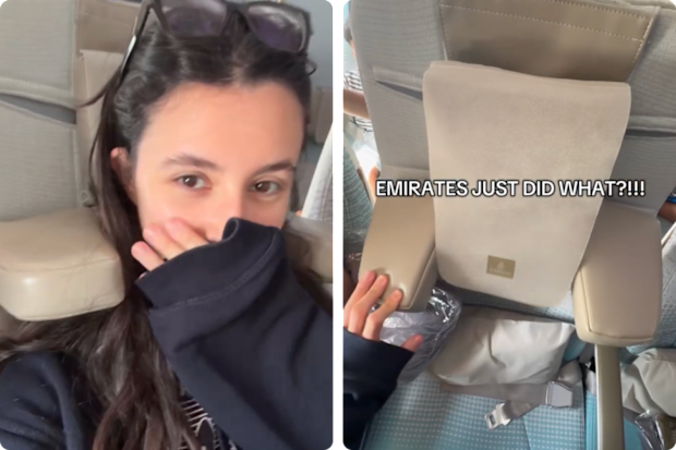 A woman showing off a new headrest on board emirates planes
