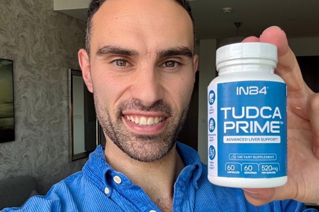 Biohacker Lucas Aoun shows a supplement bottle from his brand INB4 to the camera.